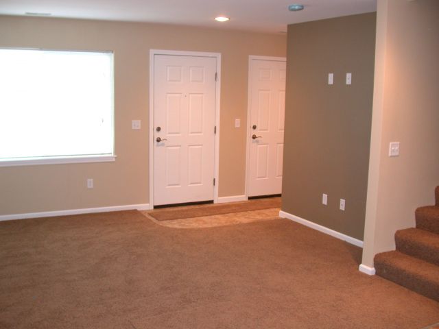 Living area with entrance and door to garage